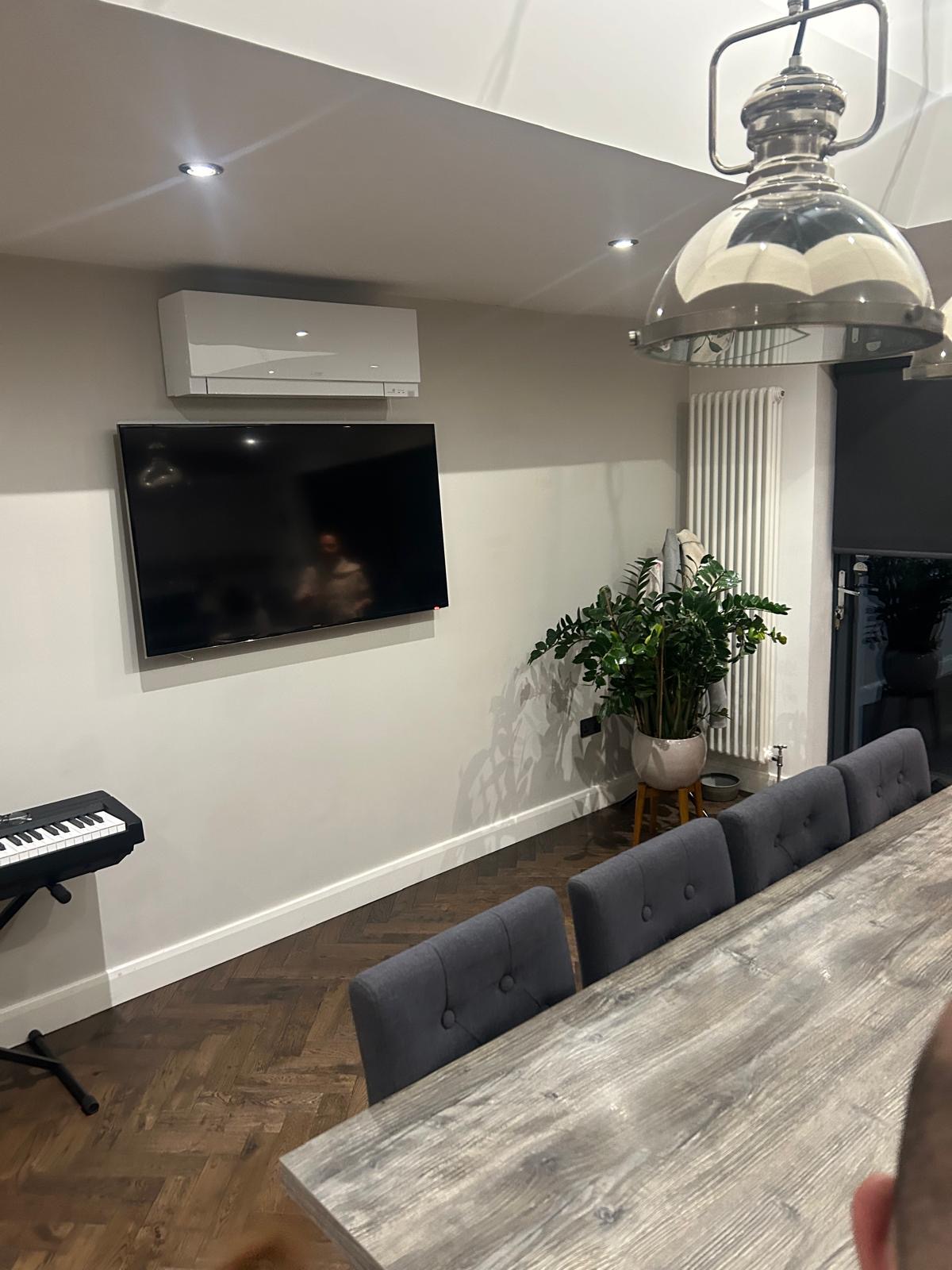 Recent air conditioning installation above dining area TV